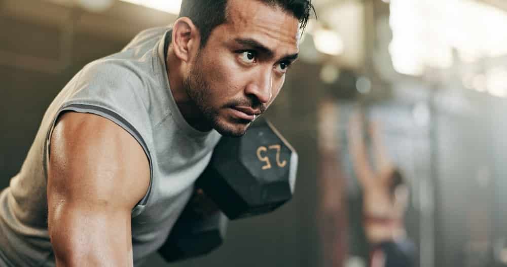 A man at the gym lifting weights