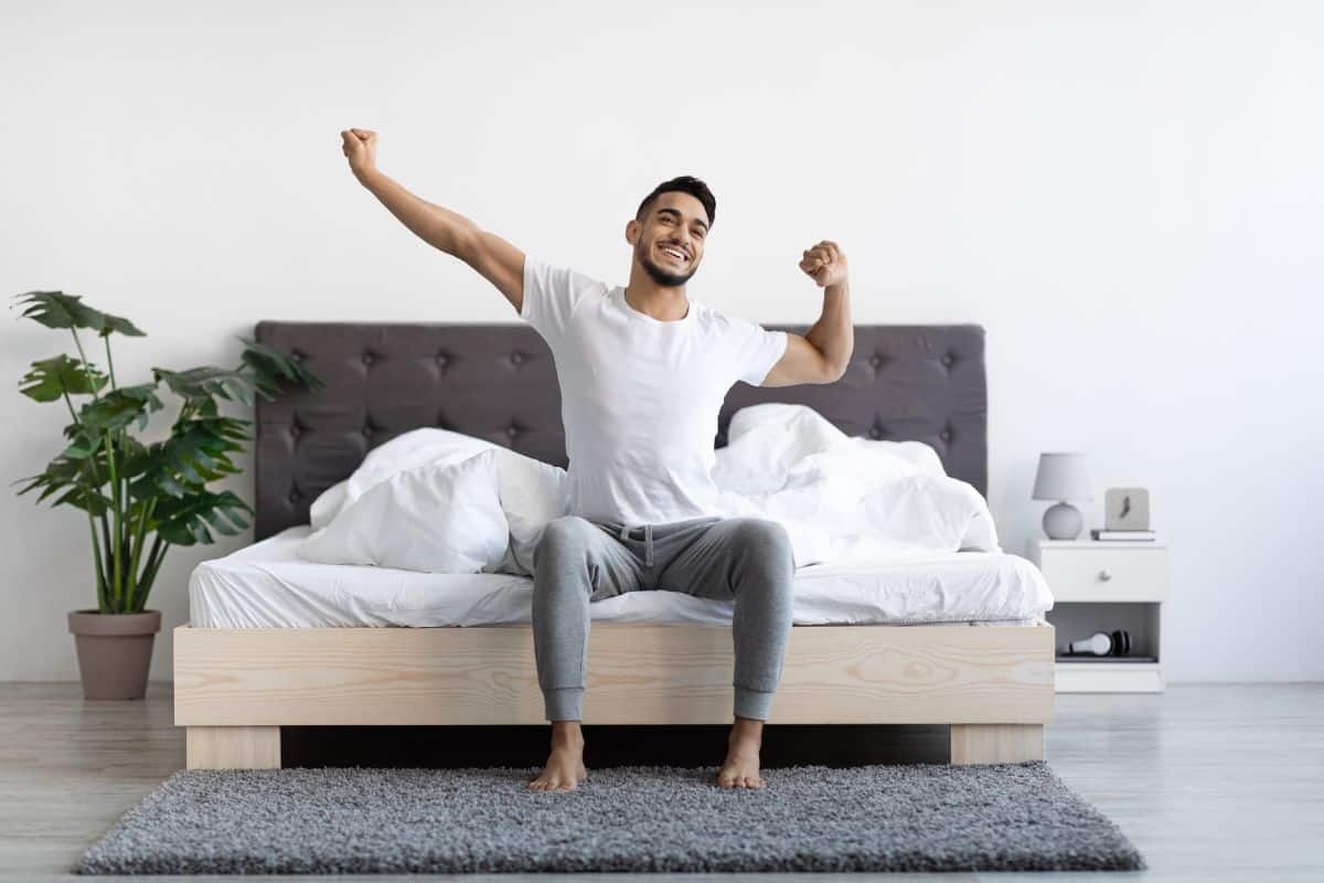 A man waking up and stretching